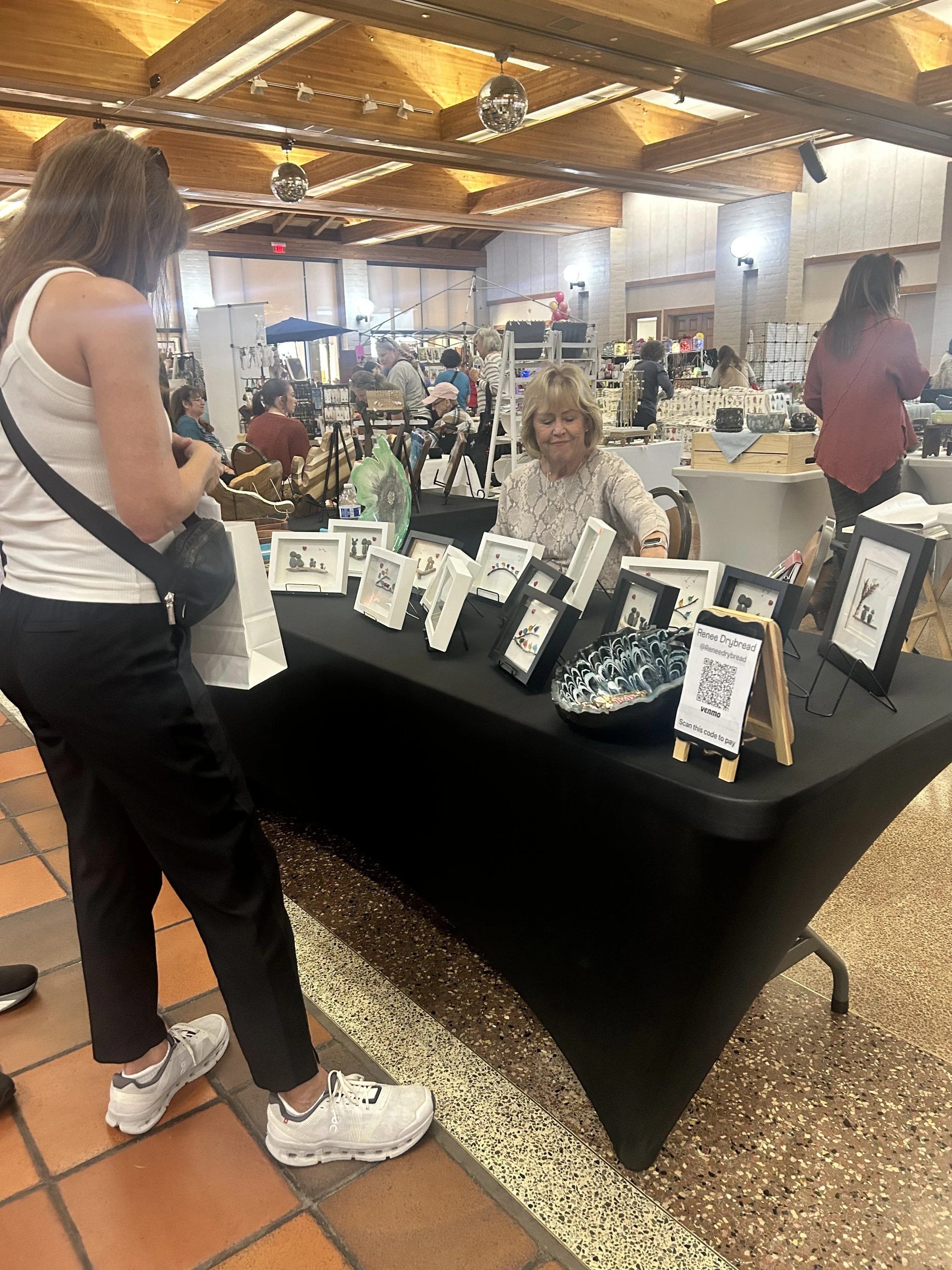 Vendors staffing a table at a past Community Faire